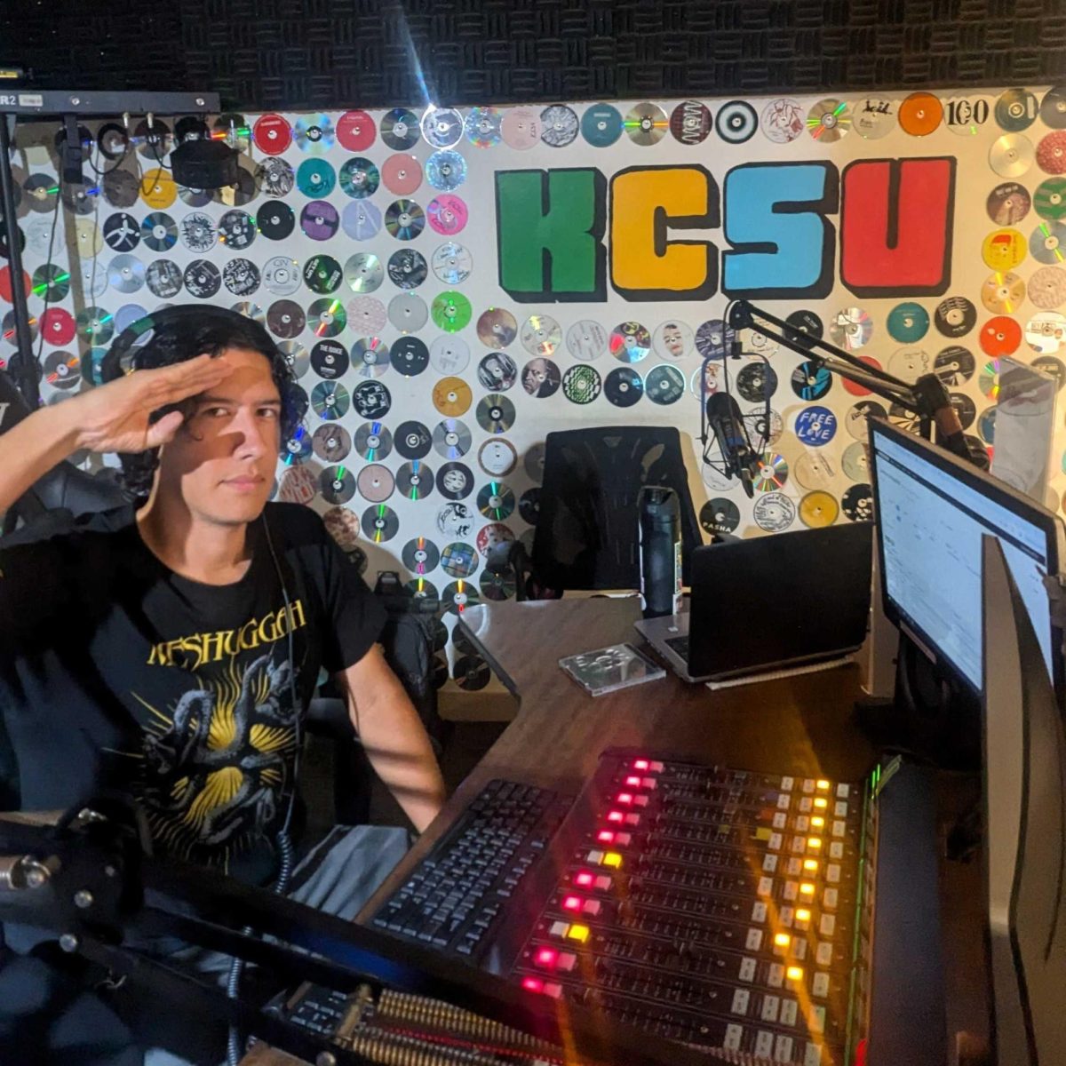 DJ Operator looking up from the board in the KCSU Studio.