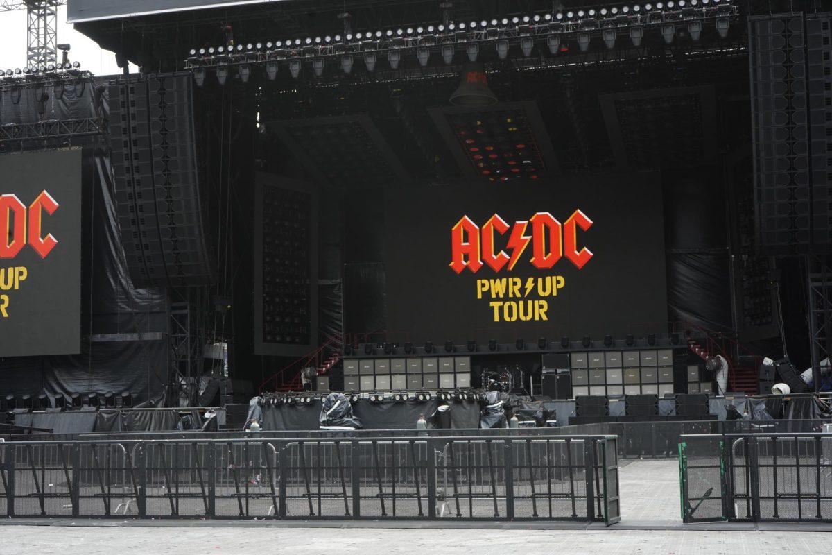 AC/DC's production team setting up the stage for their July 28 performance at Empower Field. 